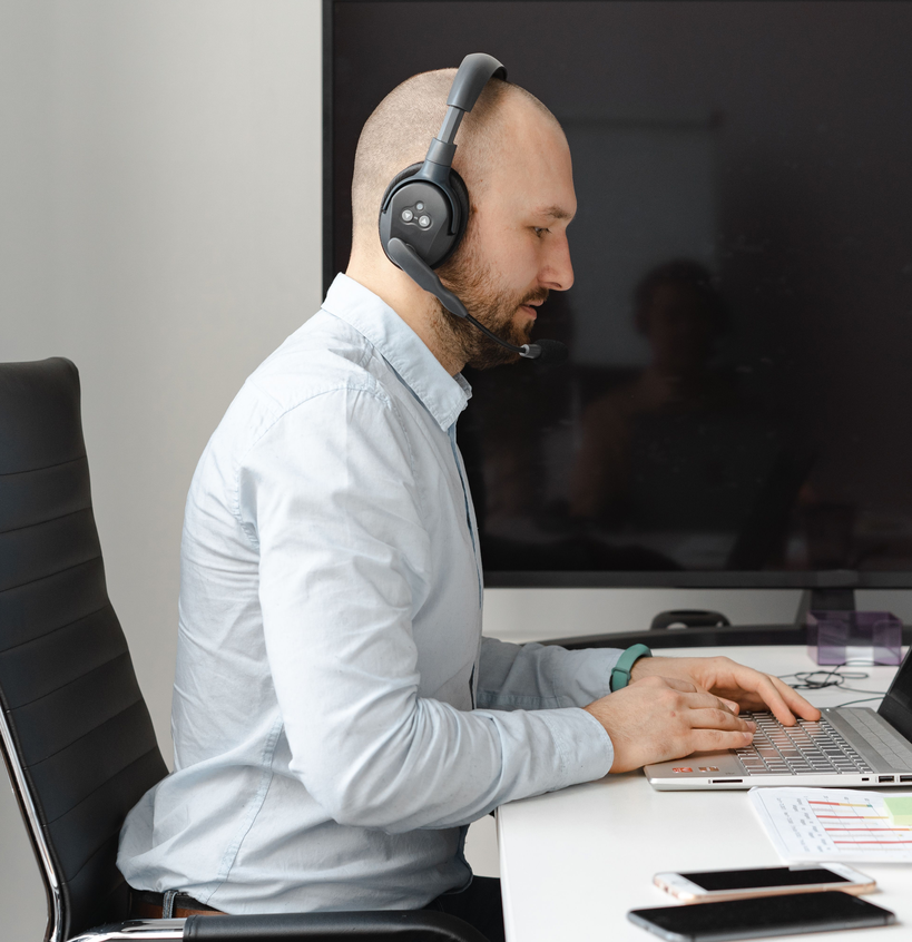 Front Desk Pro Solutions remote hospitality support specialist working on a laptop