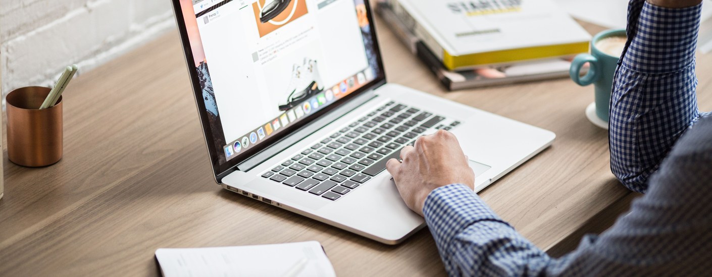 Property manager reviewing hospitality software on a laptop